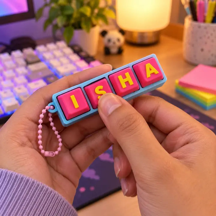 A Fidget Clicker held between finger and thumb at a desk, a mechanical keyboard behind it.